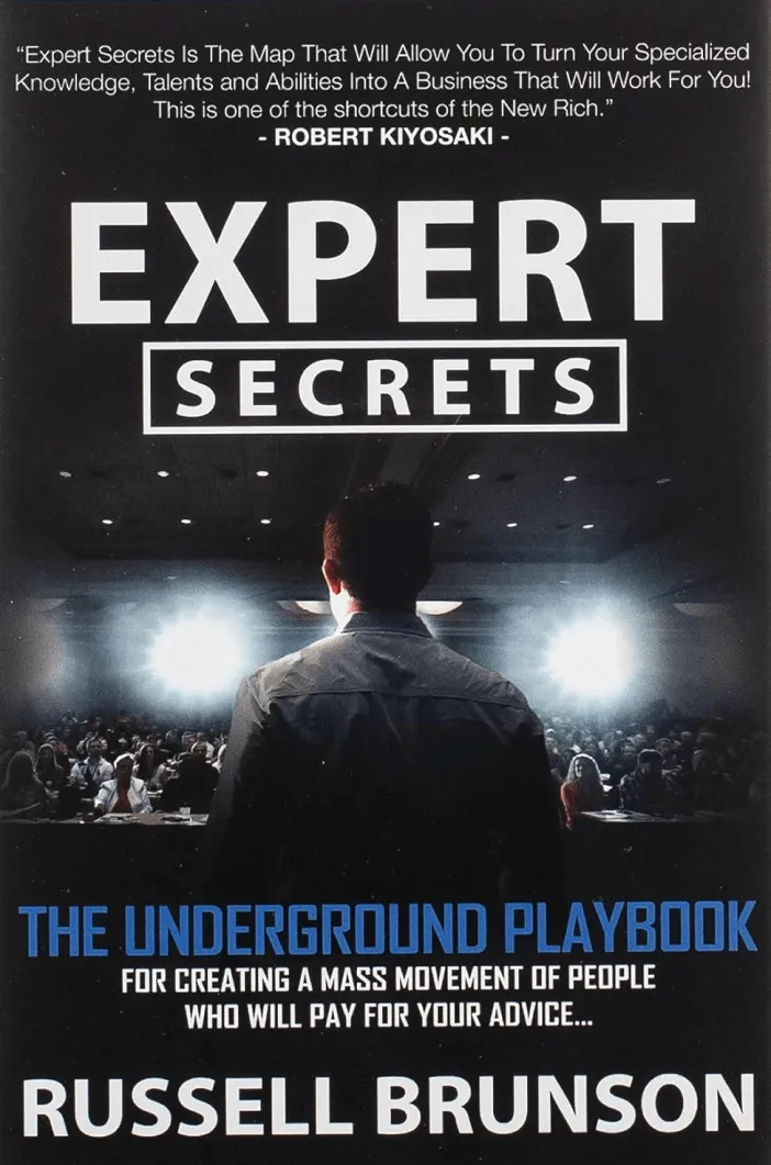 Expert Secrets book cover. Russel Brunson's back. He is in front of an audience during a presentation.